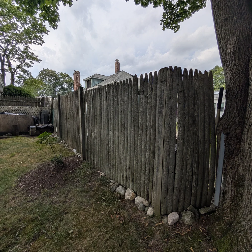 Old rotting wood fence before replacement — fence contractor Framingham MA