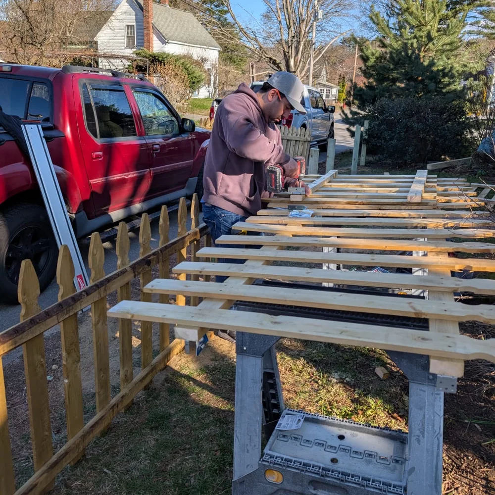 Sebastian building new cedar fence panels on site — handyman fence installation MetroWest Boston