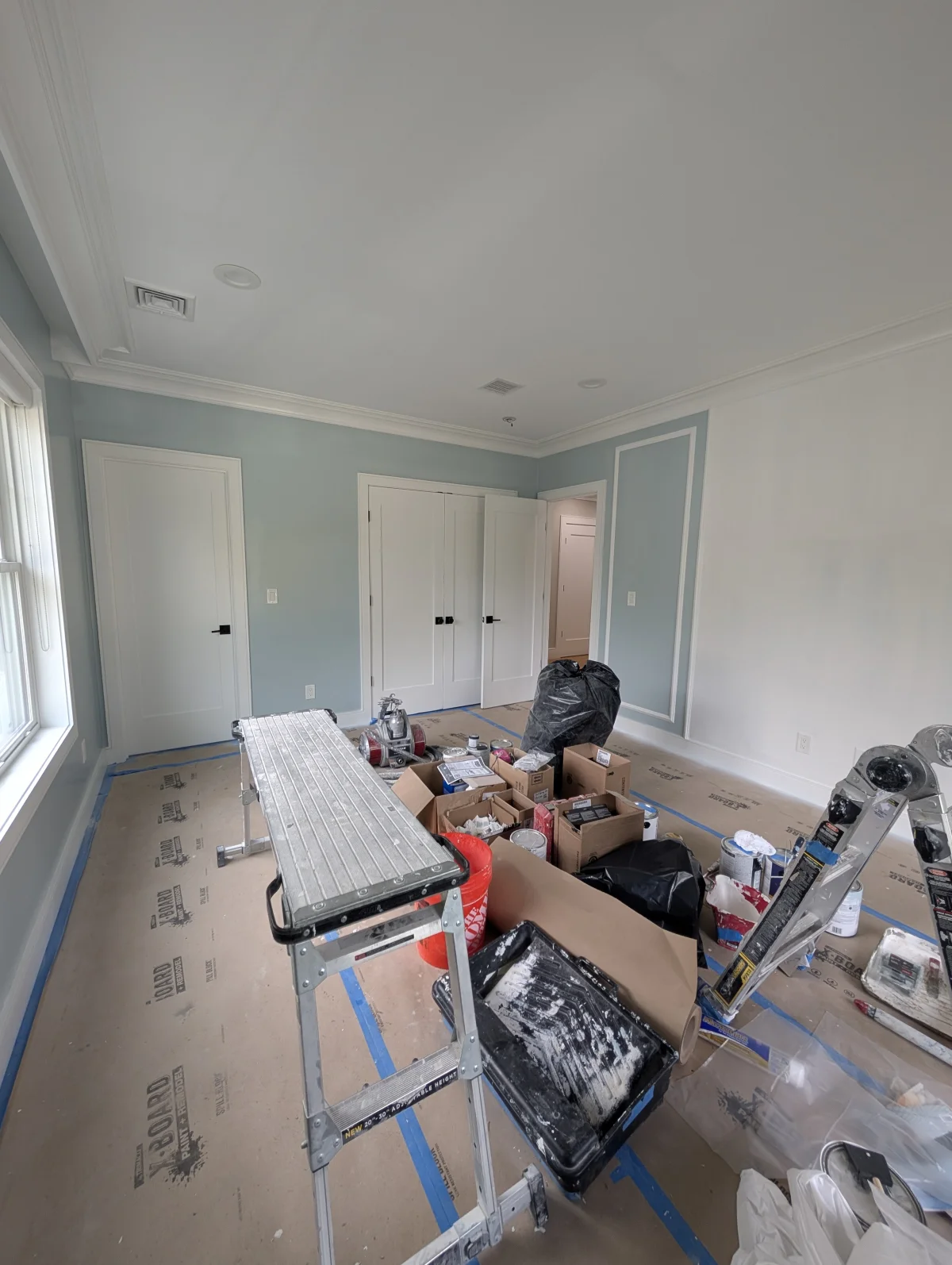 Interior painter cutting clean trim lines in Wellesley Massachusetts